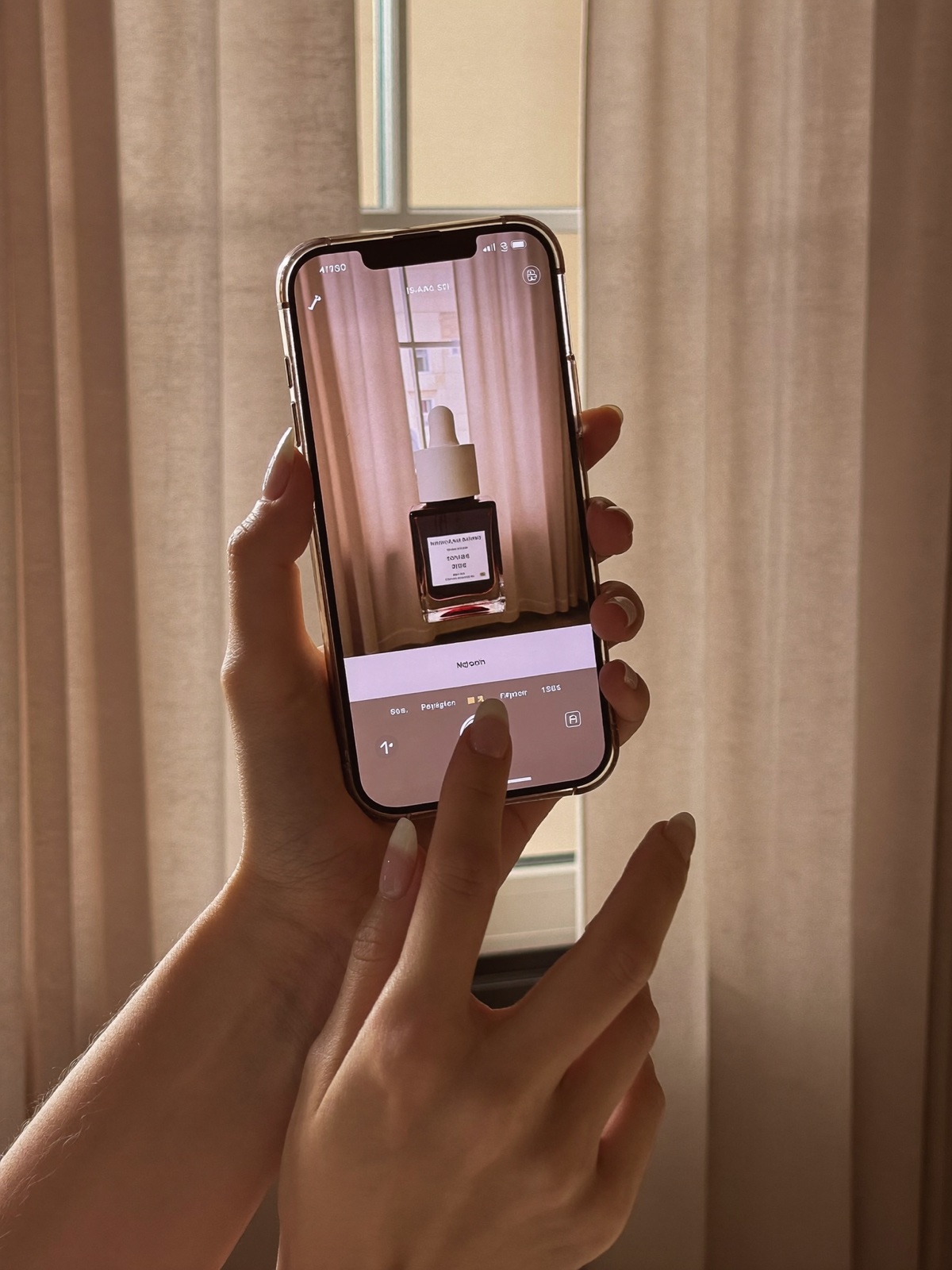 A hand holding a phone, scanning a skincare product label with Glowé
